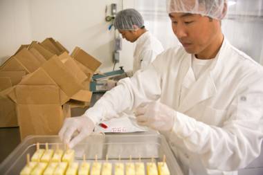 Fresh pineapple pops are being packaged at SasaPops, a Las Vegas based company that sells handmade frozen pops, Monday, July 16, 2012.